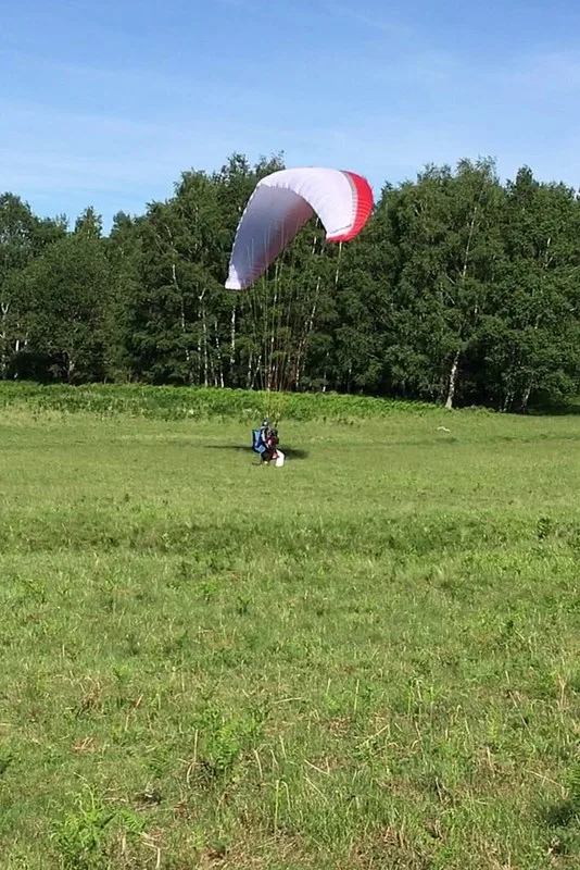 Passager et moniteur de retour sur la terre ferme après un vol en biplace